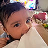 Raivy Alexander is registered to the contest to win money with this photo: baby, child, blanket, face, hand, indoor, person, television, toy, curly_hair, cute, closeup, home, infant, nibble, soft, cozy, lying_down, relaxed, colorful_background