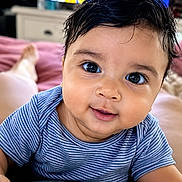 Raivy Alexander joined the competition — help win amazing prizes! baby, child, face, smile, blue_shirt, striped_clothing, big_eyes, close_up, indoor, television, blurred_background, soft_surface, cute, portrait, person, infant, happy, skin, hair, lying_down