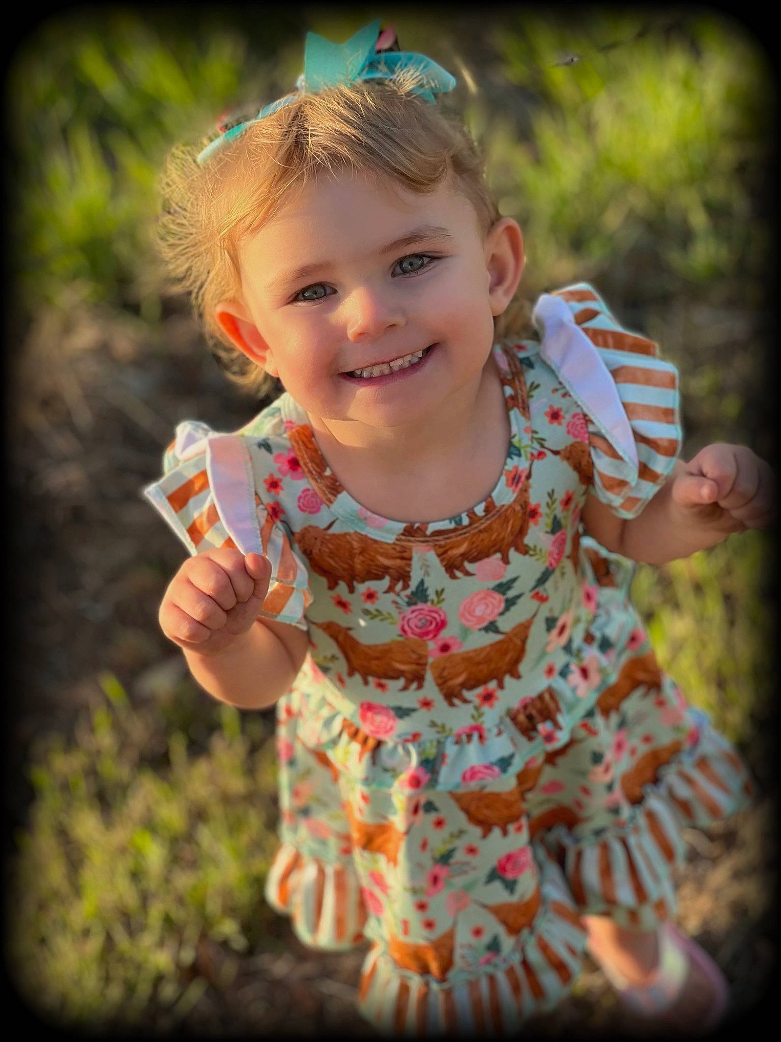 Everleigh is registered to the contest to win money with this photo: baby_toddler_clothing, cool, face, facial_expression, finger, flash_photography, gesture, grass, hand, happy, joy, leaf, lip, people_in_nature, person, plant, skin, sleeve, smile, standing