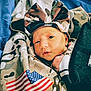 baby, infant, bow, headband, camouflage, blanket, flag, american_flag, fabric, blue_background, closeup, portrait, cute, sleepy, wrapped, soft, child, person, newborn, clothing