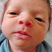 Jackson is registered to the contest to win money with this photo: baby, newborn, face, closeup, infant, person, skin, eyes, mouth, hair, clothing, blue, cute, tongue, indoors, soft, expression, young, child, portrait