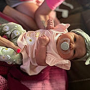 Isabella is registered to the contest to win money with this photo: architecture, baby, bodypart, bonnet, building, cap, clothing, couch, face, finger, furniture, hand, happy, hat, head, newborn, person, photography, portrait, smile