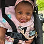 Kaliyah joined the competition — help win amazing prizes! baby, smiling, stroller, pink_headband, bib, pacifier, pacifier_clip, black_straps, outdoor, green_grass, diaper, cute, infant, happy, child, person, seat_belt, clothing, headwear, closeup