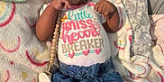 Kaliyah is registered to the contest to win money with this photo: baby, infant, smiling, onesie, pacifier, blanket, lying_down, cute, child, clothing, happy, indoors, patterned, soft, person, toddler, skin, head, hands, feet