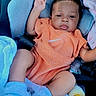 baby, baby_accessories, blanket, blue_socks, bottle, car_seat, casual, child, comfort, cute, indoors, infant, orange_clothing, pacifier, person, portrait, relaxed, resting, seatbelt, young_child