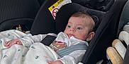 Keid is registered to the contest to win money with this photo: baby, car_seat, blanket, infant, child, car, seatbelt, window, interior, clothing, person, young, cute, sitting, safety, soft, pattern, headrest, seat, travel