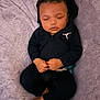 Kamarion joined the competition — help win amazing prizes! baby, sleeping, black_hoodie, black_pants, blanket, soft_texture, infant, peaceful, hands_clasped, foot, cozy, cute, child, indoors, portrait, resting, young_child, peaceful_expression, clothing, relaxation