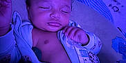 Kamarion joined the competition — help win amazing prizes! baby, sleeping, infant, onesie, pajamas, curly_hair, closed_eyes, hand, blanket, pillow, indoor, purple_light, cute, peaceful, portrait, child, cozy, soft, relaxed, sleep