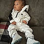 Kamarion joined the competition — help win amazing prizes! toddler, child, sneakers, white_clothing, tracksuit, couch, indoor, relaxed, casual, footwear, fabric, comfort, person, leisure, sitting, curious, young_child, hoodie, apparel, home