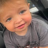 Ryker is registered to the contest to win money with this photo: toddler, child, baby, portrait, smiling, face, eyes, blond_hair, rosy_cheeks, car, car_seat, vehicle, indoors, close_up, casual_clothing, gray_shirt, seated, looking_at_camera, cute, photography