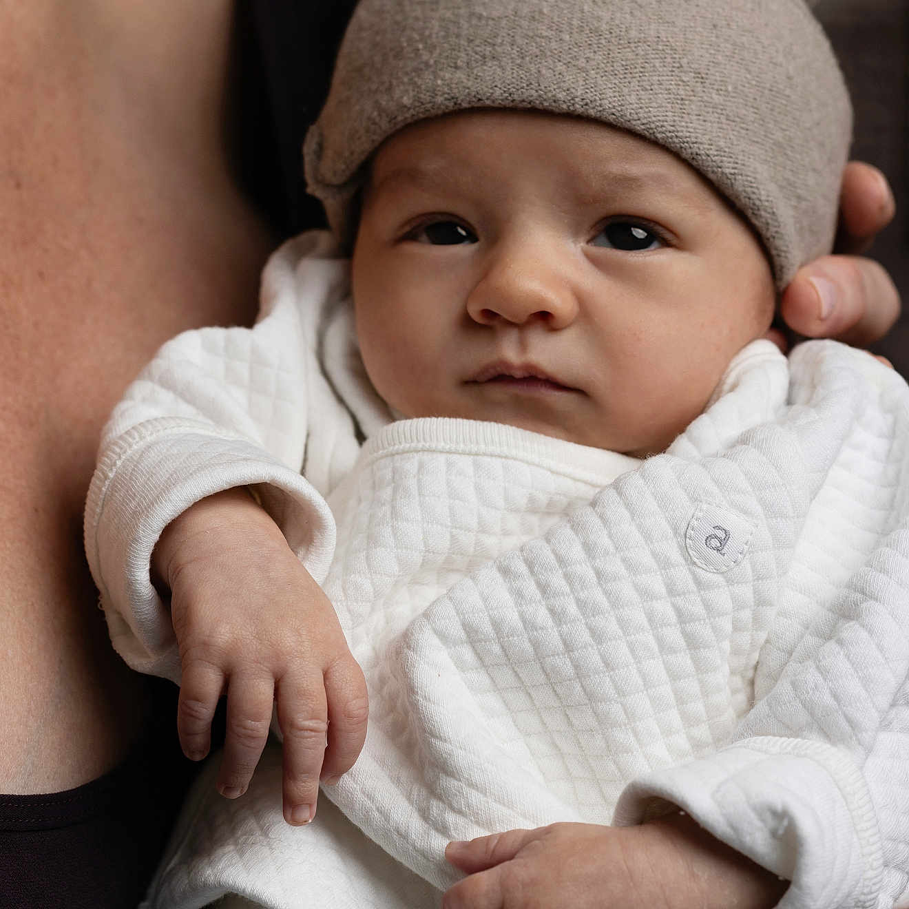Adler is registered to the contest to win money with this photo: baby, beanie, bodypart, bonnet, cap, clothing, face, finger, hand, happy, hat, head, hoodie, knitwear, newborn, person, photography, portrait, smile, sweater