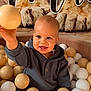 Maë participe au concours pour gagner de l'argent avec cette photo : toddler, child, ball_pit, beige_balls, white_balls, smiling, happy, hoodie, indoor, play, cute, baby, portrait, face, childhood, fun, hand, toy, expression, person