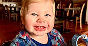Cameron joined the competition — help win amazing prizes! toddler, child, smile, plaid_shirt, blue_eyes, indoor, restaurant, table, wooden_table, watch, messy_face, happy, person, clothing, face, portrait, sitting, cute, baby, casual