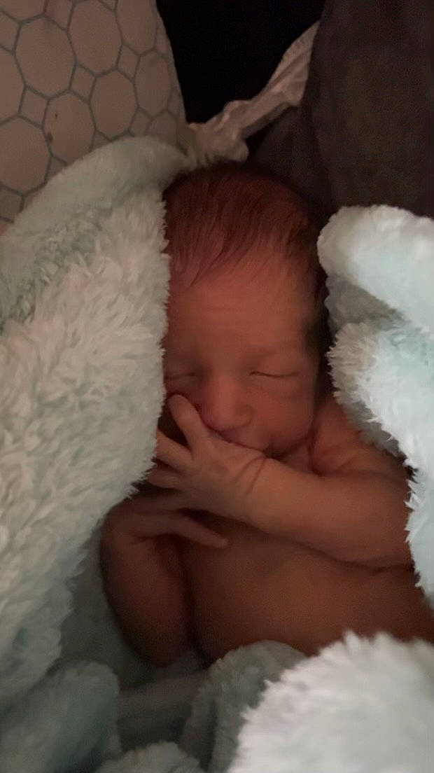 Brody is registered to the contest to win money with this photo: baby, cheek, child, comfort, ear, eye, eyebrow, eyelash, finger, fur, hand, head, headgear, iris, linens, nose, person, skin, textile, toddler