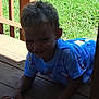 La'Kailyn joined the competition — help win amazing prizes! child, toddler, crawling, porch, wooden_floor, blue_shirt, grass, outdoor, sunlight, shadow, happy, smile, face, hair, person, nature, daylight, playful, young, casual