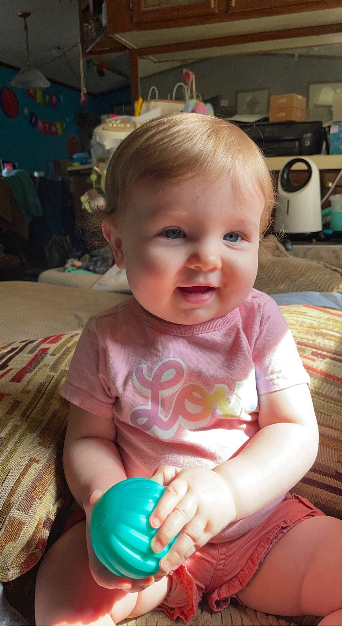 Karla is registered to the contest to win money with this photo: baby, baby_toddler_clothing, cheek, child, chin, eye, fun, head, home_appliance, human_body, iris, kitchen_appliance, mouth, person, pink, product, skin, smile, standing, thigh