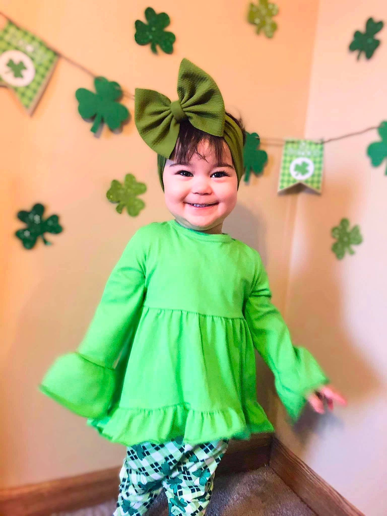 Emberlynn is registered to the contest to win money with this photo: baby_toddler_clothing, child, costume, event, fashion_design, fun, green, happy, hat, holiday, joy, leaf, orange, outerwear, pattern, person, room, sleeve, smile, standing