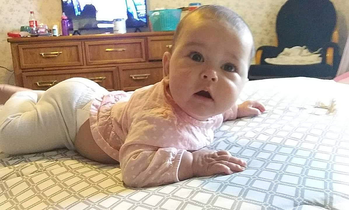 Emberlynn is registered to the contest to win money with this photo: baby, cheek, child, crawling, face, floor, flooring, head, mouth, nose, person, sitting, skin, toddler, tummy_time