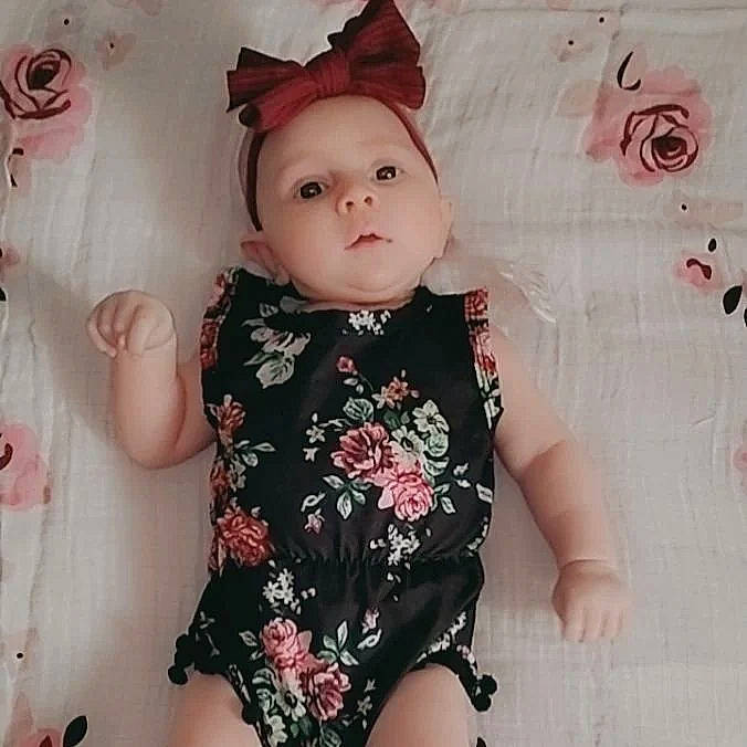 Tinsley joined the competition — help win amazing prizes! baby, baby_toddler_clothing, cap, cheek, child, costume_hat, doll, dress, eyelash, head, headgear, human_body, lip, outerwear, pattern, person, pink, skin, sleeve, textile