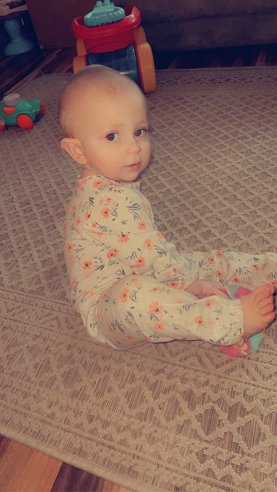 Tinsley is registered to the contest to win money with this photo: baby, baby_toddler_clothing, carmine, carpet, cheek, child, comfort, floor, flooring, fun, hardwood, human_leg, pattern, person, play, sitting, skin, sleeve, toddler, toy