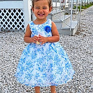 Azyrah is registered to the contest to win money with this photo: child, girl, toddler, smiling, portrait, outdoor, dress, floral_dress, blue_bow, standing, gravel, porch, house, summer, fashion, happy, shoes, garden, daylight, person