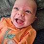baby, smiling, orange_outfit, koala, leaf, infant, happy, face, eyes, mouth, clothing, texture, fabric, cute, child, portrait, lying_down, indoor, closeup, person