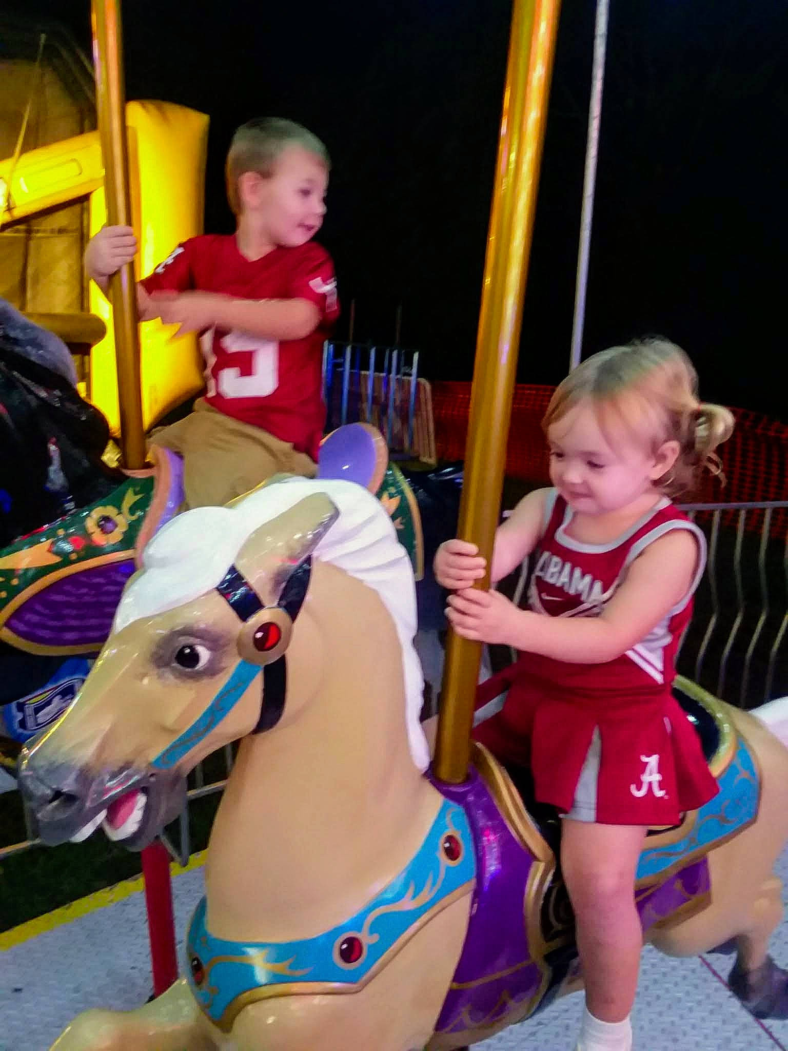 Haley joined the competition — help win amazing prizes! amusement_ride, bridle, carousel, child, event, fun, head, horse, horse_tack, joy, leisure, nonbuilding_structure, person, photograph, playground, recreation, shorts, snapshot, thigh, toddler