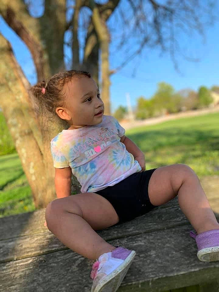Alaiyah is registered to the contest to win money with this photo: face, flash_photography, fun, grass, happy, human_leg, leg, leisure, long_hair, people_in_nature, person, plant, recreation, shorts, sky, summer, t_shirt, thigh, toddler, tree