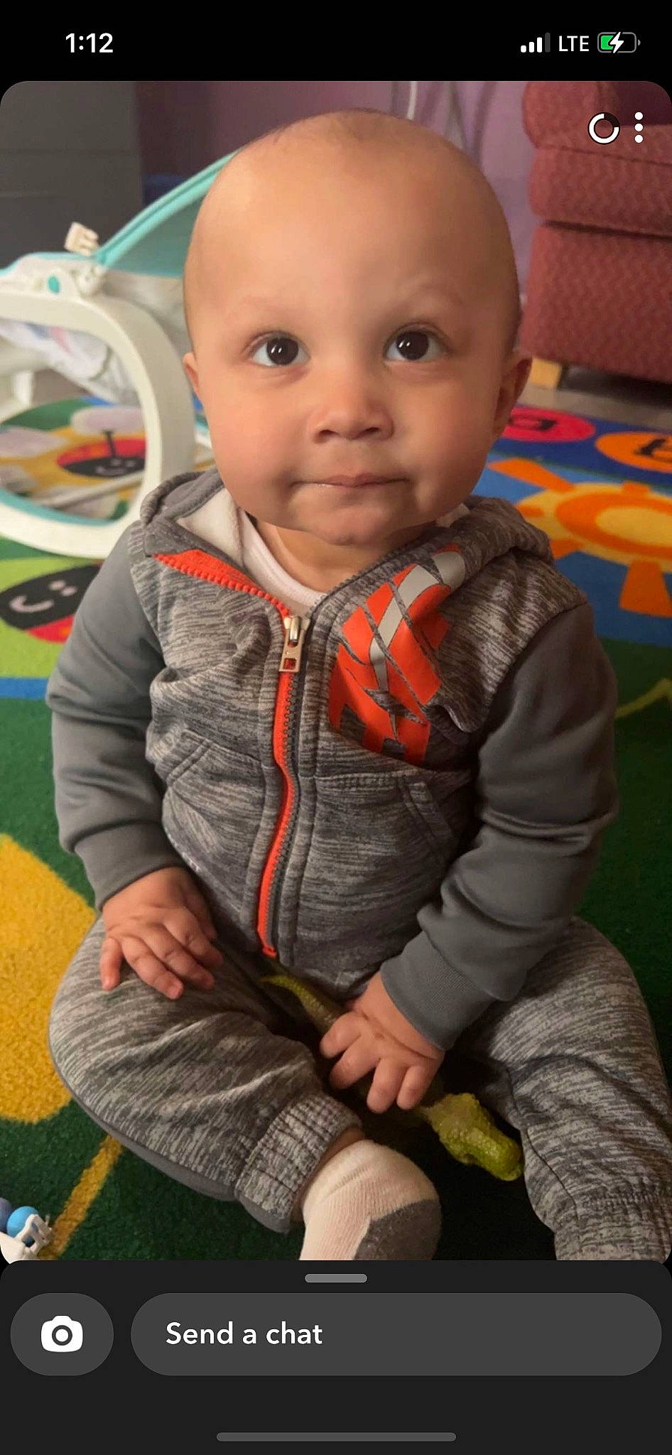 Lux is registered to the contest to win money with this photo: baby, baby_toddler_clothing, black, cheek, child, finger, flooring, fun, grass, happy, iris, nose, orange, person, photograph, skin, sleeve, smile, snapshot, standing