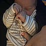 Rónán is registered to the contest to win money with this photo: baby, newborn, sleeping, hand, onesie, striped_clothing, bear_design, person, infant, skin, fingernails, cute, cozy, rest, child, soft_lighting, cradling, closeup, warm, peaceful
