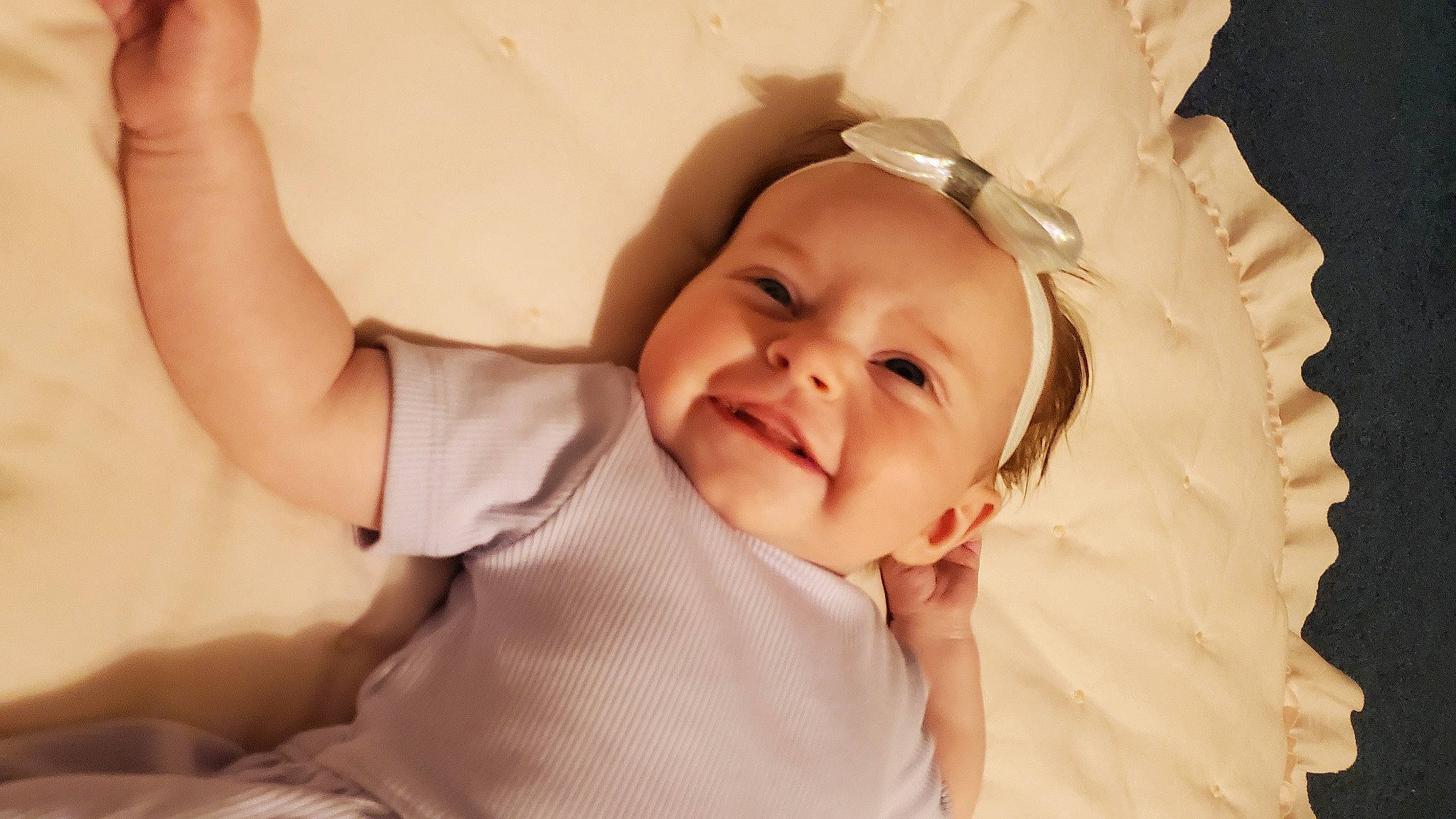 Minnow is registered to the contest to win money with this photo: baby, baby_toddler_clothing, cheek, child, comfort, dress, event, fashion_accessory, flash_photography, fun, gesture, happy, headgear, headwear, linens, mouth, pattern, person, skin, smile