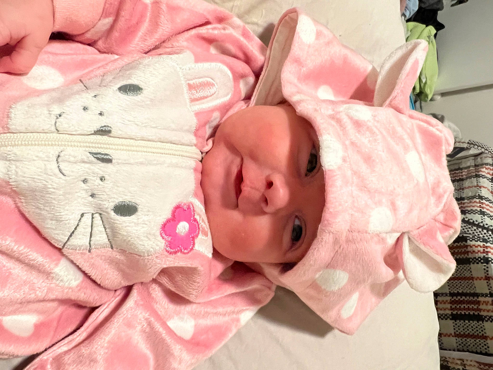 Summer is registered to the contest to win money with this photo: baby, baby_products, baby_toddler_clothing, carmine, cheek, child, collar, comfort, eyelash, fashion_accessory, headwear, linens, lip, pattern, person, petal, pink, pollinator, skin, sleeve