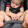toddler, sleeping, car_seat, child, older_child, hands, feet, straps, indoors, curious, face, hair, clothing, seat, resting, young_child, safety, car, people, portrait