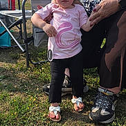 Kaela Robinson joined the competition — help win amazing prizes! toddler, child, woman, hand_holding, outdoor, grass, chair, pink_shirt, unicorn_design, black_leggings, sandals, adult, footwear, sunlight, daytime, person, nature, family, support, casual_clothing