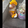 Deyana is registered to the contest to win money with this photo: baby, child, comfortable, cozy, crocheted_hat, crocheted_shorts, crocheted_socks, curious, cute, gift_basket, gray_couch, home, indoor, infant, portrait, ribbons, sitting, soft_lighting, wrapped_gift, yellow