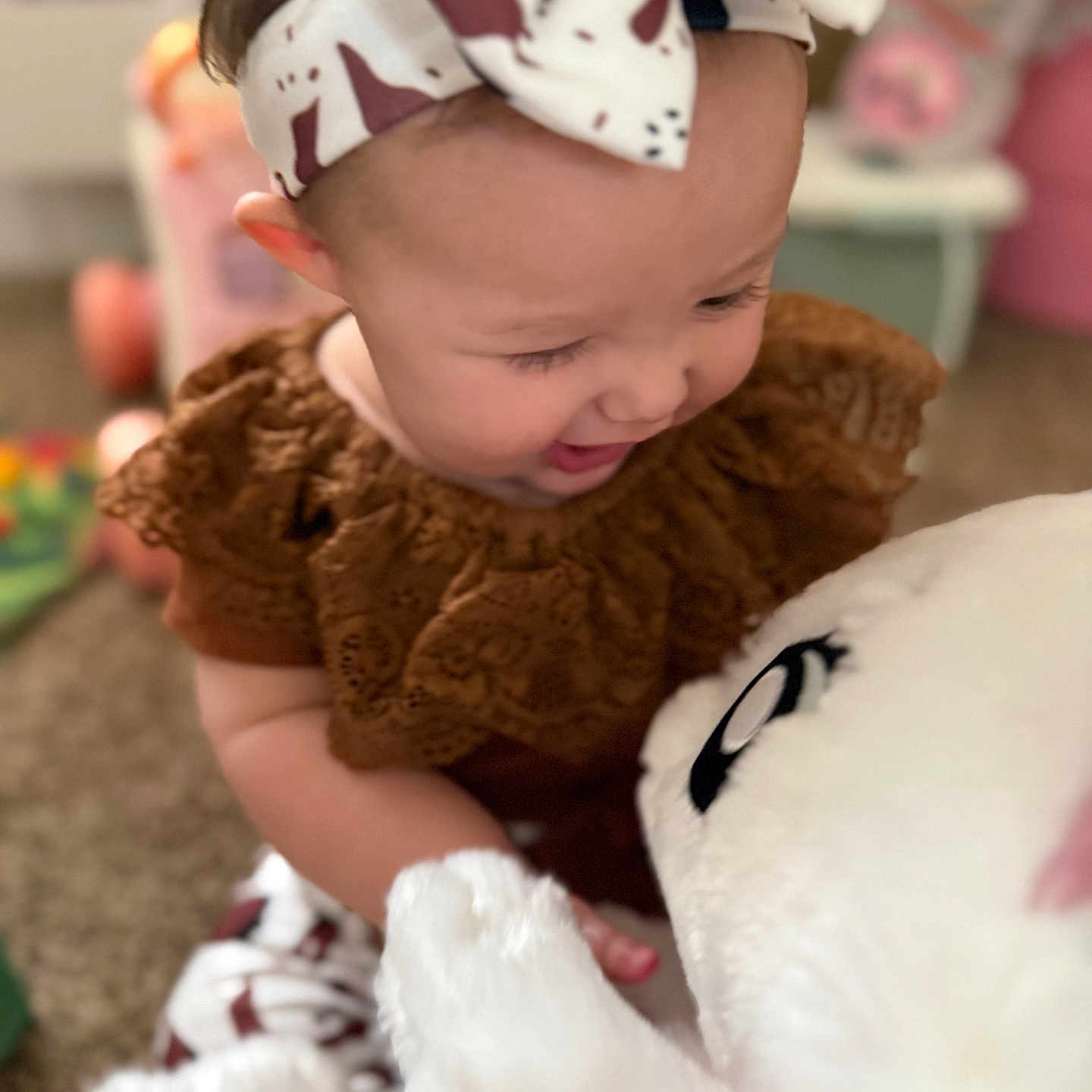 Maralie is registered to the contest to win money with this photo: accessories, baby, babylaughing, bodypart, bonnet, clothing, dress, face, finger, hand, happy, hat, head, headband, newborn, person, photography, portrait, smile, teddybear