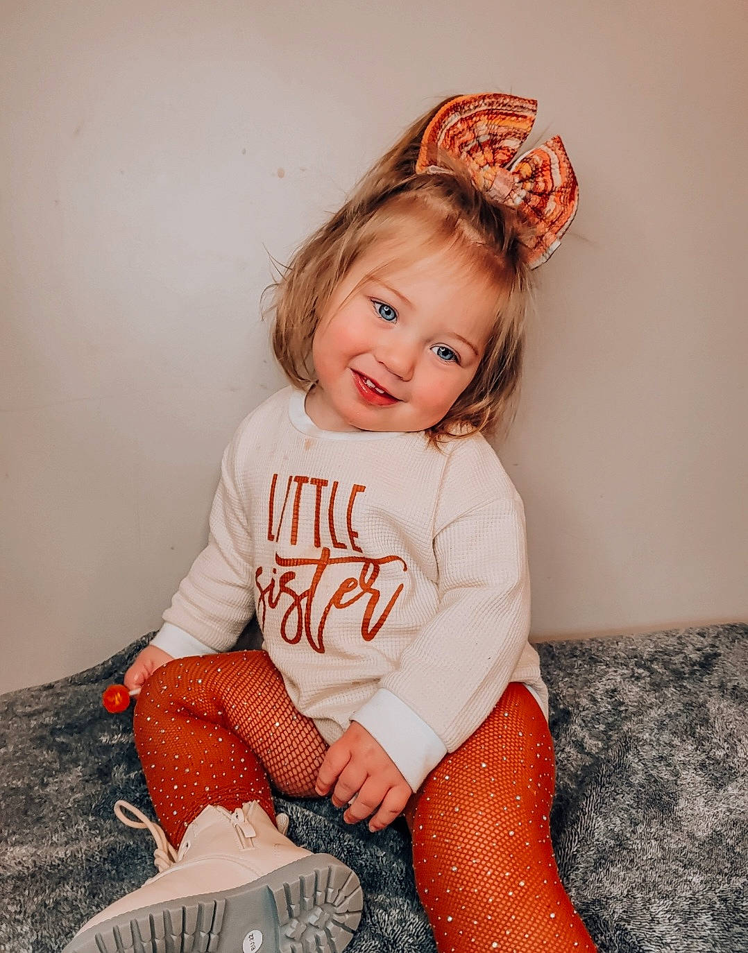 Emmalynn is registered to the contest to win money with this photo: baby_toddler_clothing, brown_hair, child, eye, fun, hair_accessory, happy, headpiece, human_leg, jewellery, joy, knee, lip, pattern, person, pink, skin, sleeve, smile, t_shirt