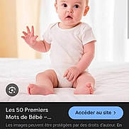Mekka Lyna a rejoint le concours — aidez-le/la à gagner de superbes lots ! baby, infant, child, onesie, white_clothing, sitting, bed, indoor, soft_lighting, curious_expression, hand_raised, young_child, portrait, cute, small_feet, light_background, human, person, early_childhood, casual