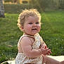 baby, child, curly_hair, smiling, clapping_hands, outdoor, grass, sunlight, reflection, cute, happy, summer, nature, portrait, infant, skin, bare_arms, sitting, daytime, warm_light