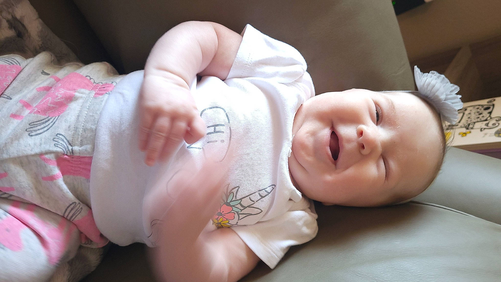 Maci is registered to the contest to win money with this photo: arm, baby, baby_toddler_clothing, cheek, chest, child, comfort, finger, flash_photography, gesture, happy, human_body, mammal, mouth, muscle, person, skin, smile, stomach, thumb