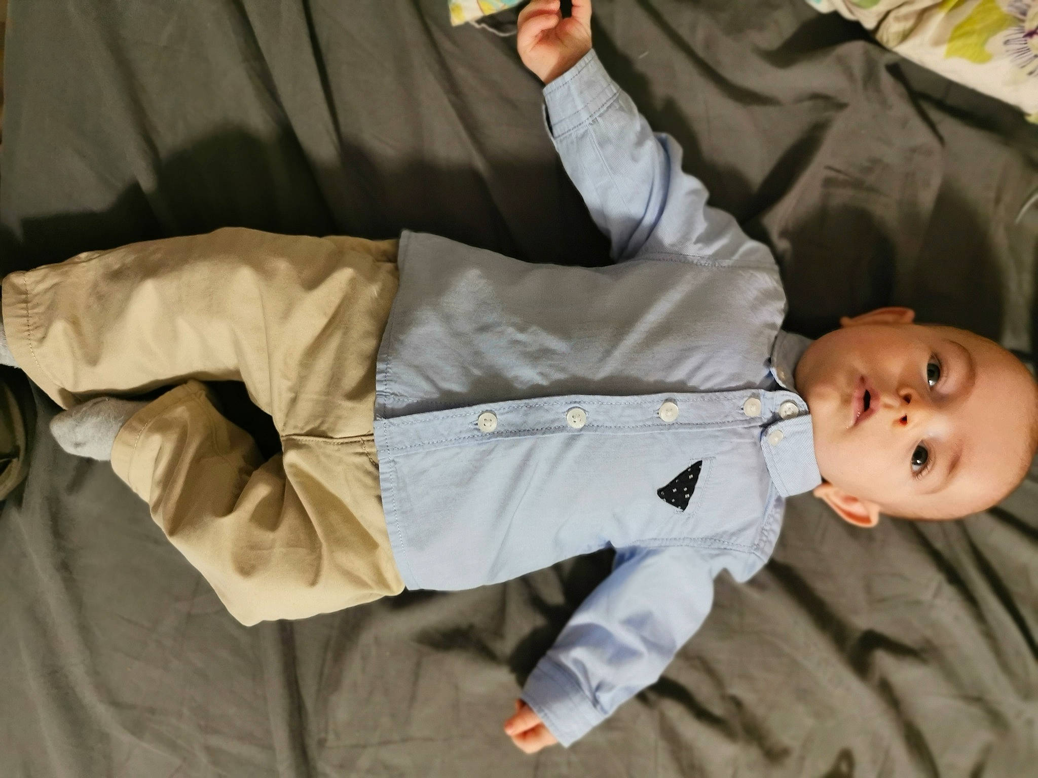 Nesta participe au concours pour gagner de l'argent avec cette photo : arm, baby, baby_products, baby_toddler_clothing, child, comfort, fun, gesture, khaki_pants, person, room, sitting, sleeve, toddler