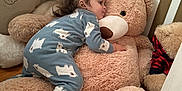 Pierre is registered to the contest to win money with this photo: toddler, child, pajamas, polar_bear_pattern, plush_toy, teddy_bear, stuffed_animal, nursery, bedroom, soft_toys, floor, wooden_floor, cozy, childhood, cute, indoor, playtime, comfort, sleepwear, young_child