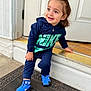 toddler, child, smiling, nike, tracksuit, blue_shoes, doorstep, welcome_mat, outdoor, happy, person, clothing, shoe, footwear, door, concrete, mat, young_child, casual, portrait