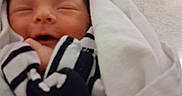 Chaos joined the competition — help win amazing prizes! baby, bedroom_furniture, blanket, closeup, cute, face, floor, hospital, human, indoor, infant, medical_equipment, newborn, peaceful, person, sleeping, smile, soft_light, striped_clothing, wrapped