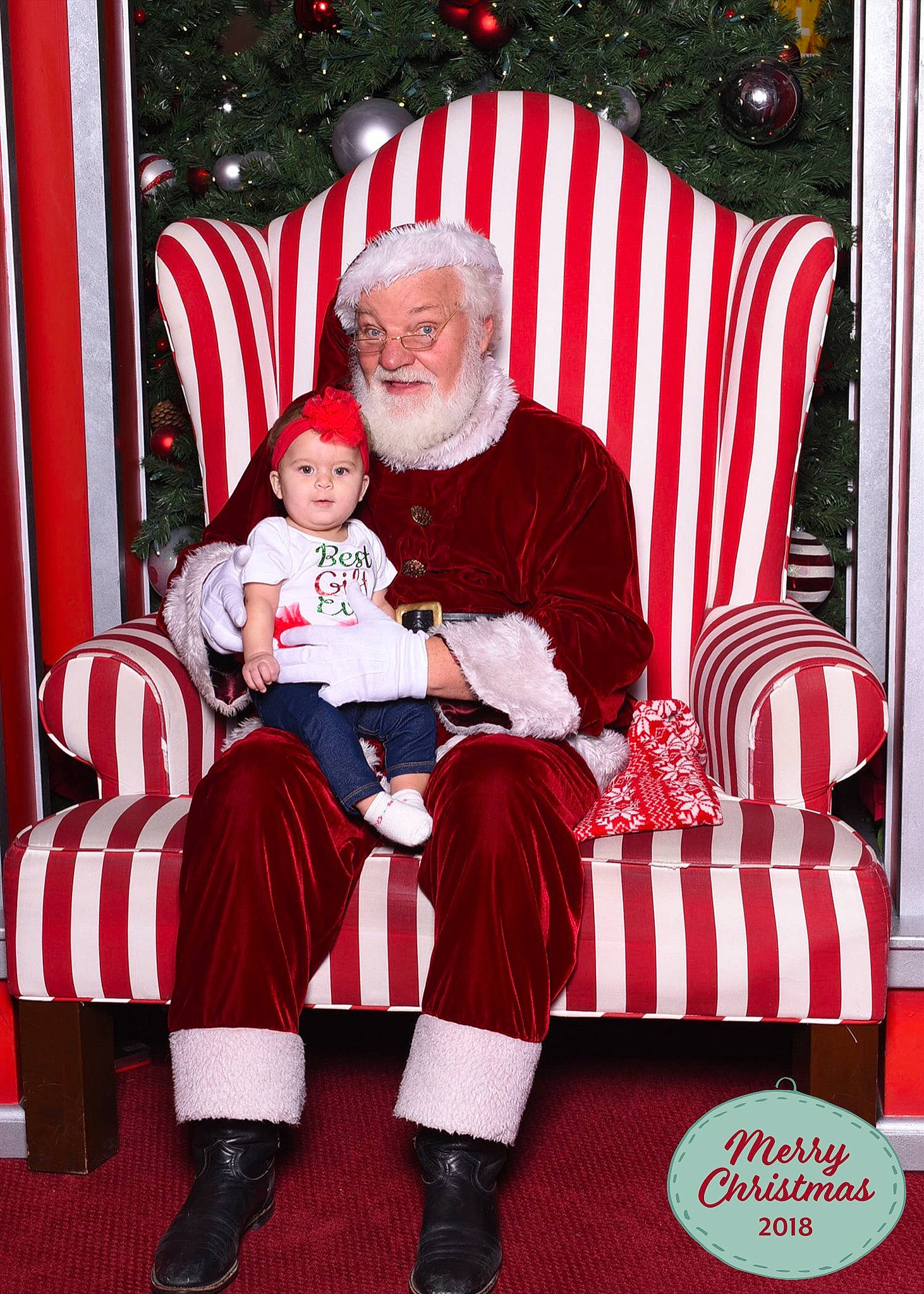 Kendall is registered to the contest to win money with this photo: christmas, christmas_decoration, event, fictional_character, fun, holiday, lap, person, product, red, santa_claus