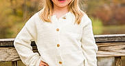 Scarlett joined the competition — help win amazing prizes! child, girl, smile, blonde_hair, white_sweater, blue_jeans, outdoor, autumn, wooden_railing, nature, portrait, happy, casual_clothing, posing, young, person, fashion, fall_foliage, daylight, cute
