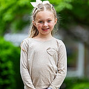 Scarlett joined the competition — help win amazing prizes! child, girl, smiling, outdoor, nature, greenery, long_sleeve_shirt, heart_detail, blue_jeans, hair_bow, portrait, happy, standing, watch, casual_clothing, daylight, cute, fashion, person, young