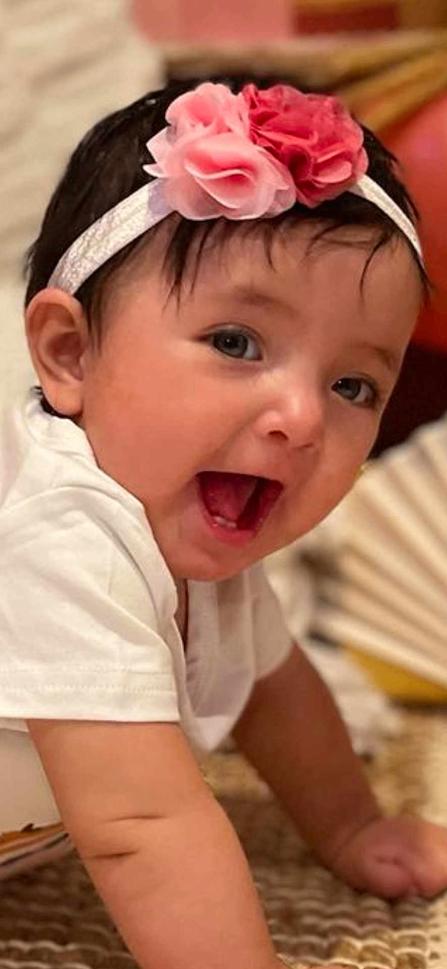 Abigail joined the competition — help win amazing prizes! baby, child, crawling, headband, pink_flower, white_shirt, happy, smiling, indoor, rug, closeup, cute, infant, skin, face, mouth_open, eyes, arm, person, young