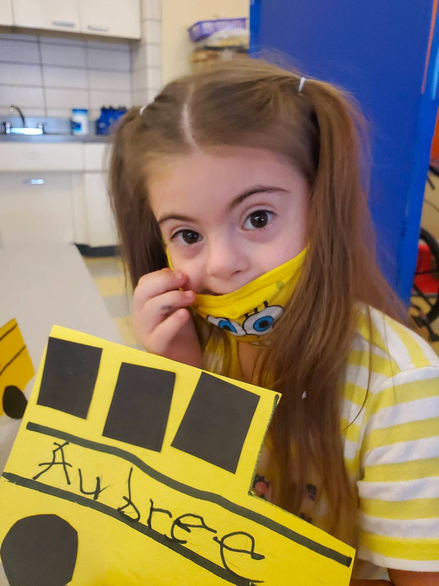 Aubree is registered to the contest to win money with this photo: blond, chair, child, desk, engineering, eyelash, facial_expression, font, fun, illustration, learning, person, photograph, play, recreation, room, science, snapshot, t_shirt, toddler