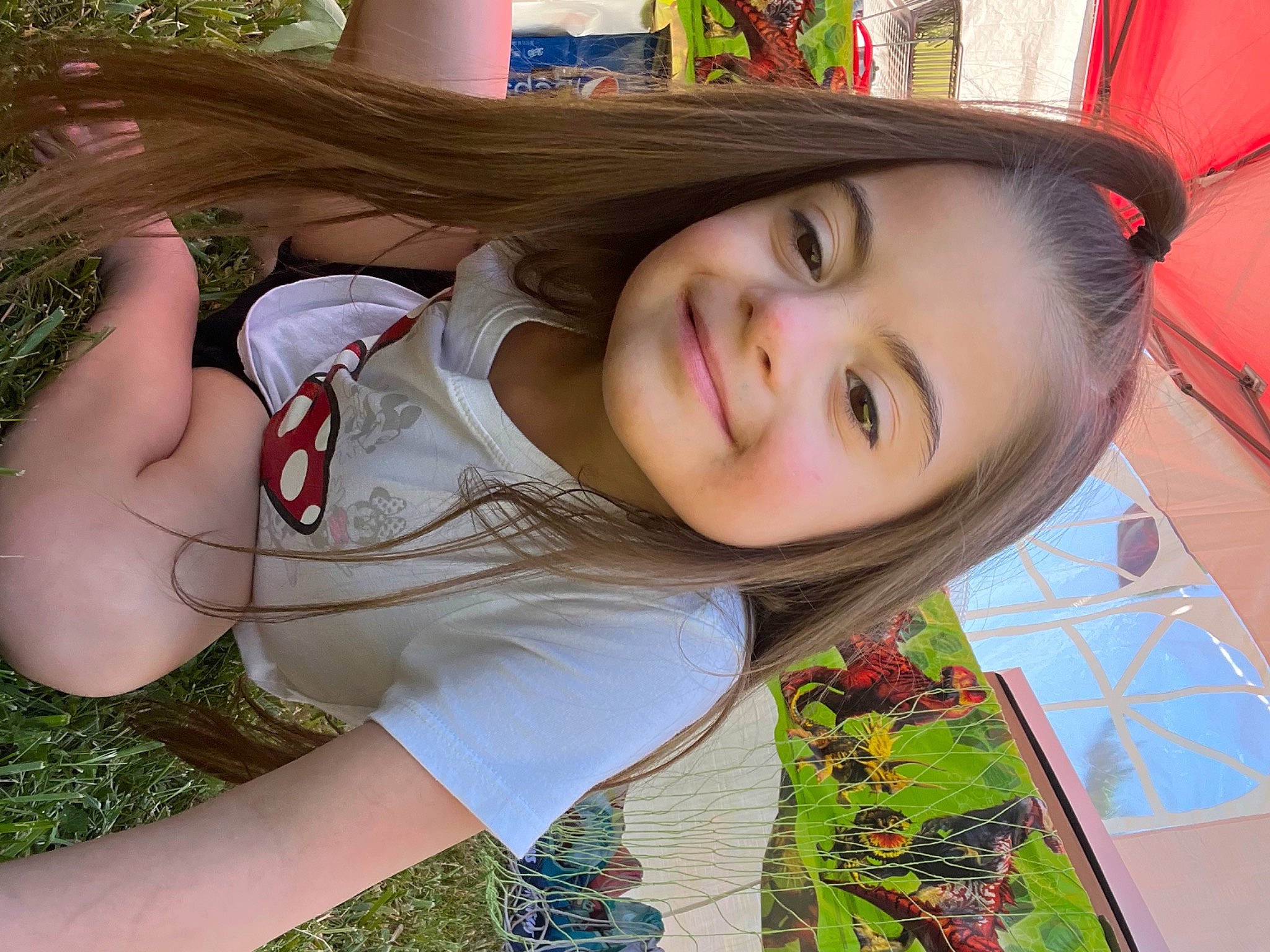 Aubree joined the competition — help win amazing prizes! bangs, black_hair, brown_hair, child, eyelash, facial_expression, fun, grass, hairstyle, happy, human_leg, joy, leisure, lip, mouth, neck, people_in_nature, person, plant, skin